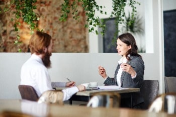 Two people chatting at a table