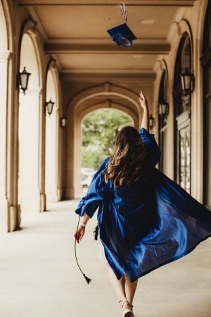 Graduate throwing hat in the air
