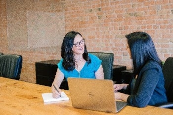 Two women talking at work