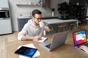 Man sitting at work desk with coffee