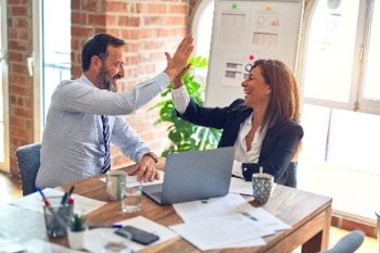 Two colleagues high-fiving 