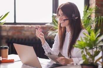 Woman looking happy on a work call