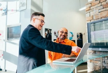 Two men looking at laptop screen