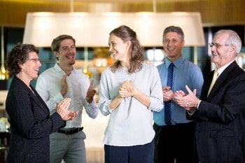 Colleagues clapping each other