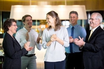 Colleagues clapping each other