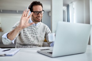 Man waving on a Zoom call