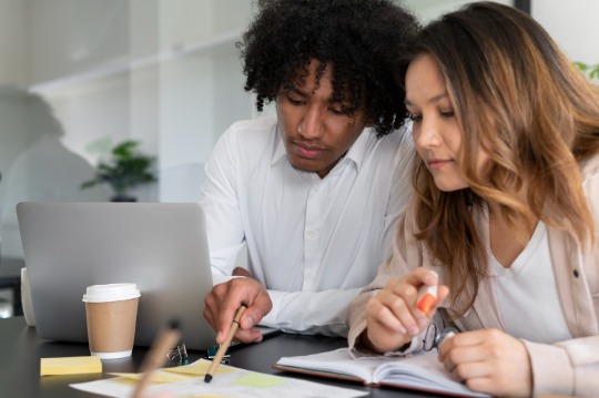 Finance colleagues working together at desk
