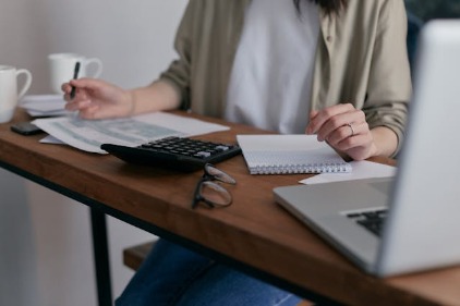 Woman sat at a desk writing her CV 