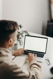 Man editing his CV on a laptop
