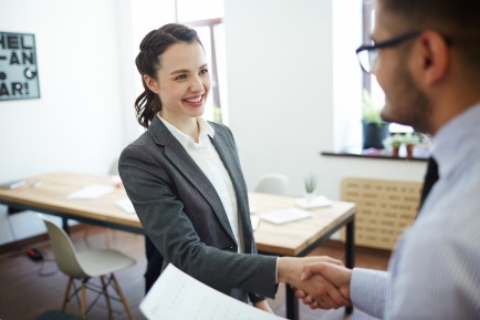 Saleswoman shaking hands with interviewer