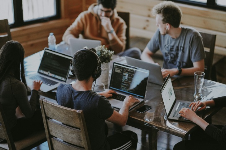 Colleagues sat working together at desk