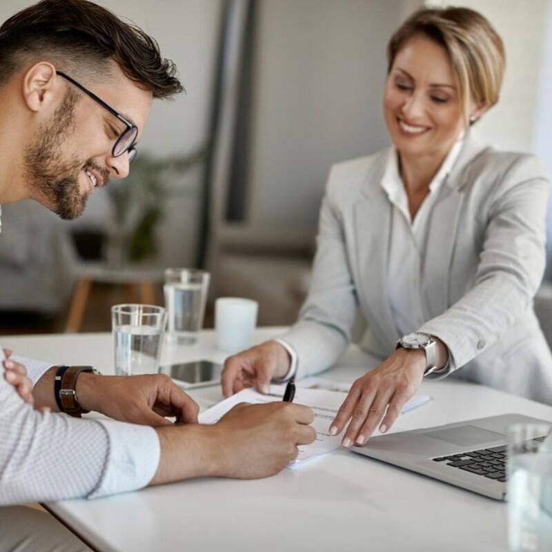 Man signing papers with insurance recruiter