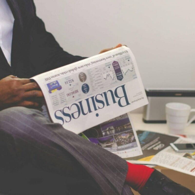 finance recruiter holding business newspaper